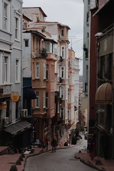 Discover the charm of Istanbul with this narrow city street lined by colorful historic buildings.
