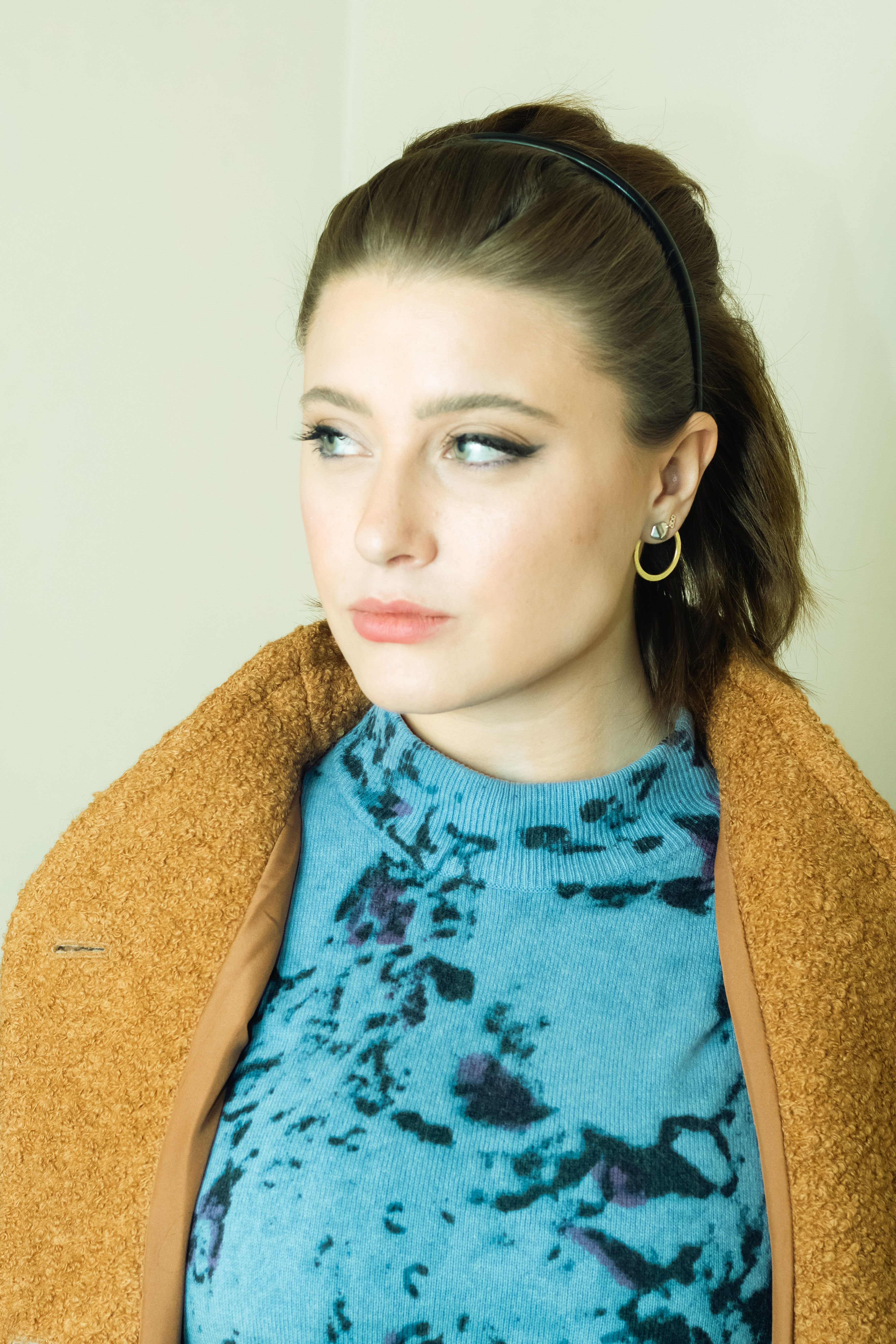 Photo of a Young Woman in a Blue Blouse and Brown Coat · Free Stock Photo