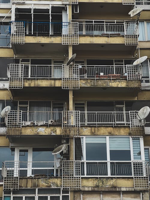 Old Satellite Dishes on the Balconies of an Apartment Building