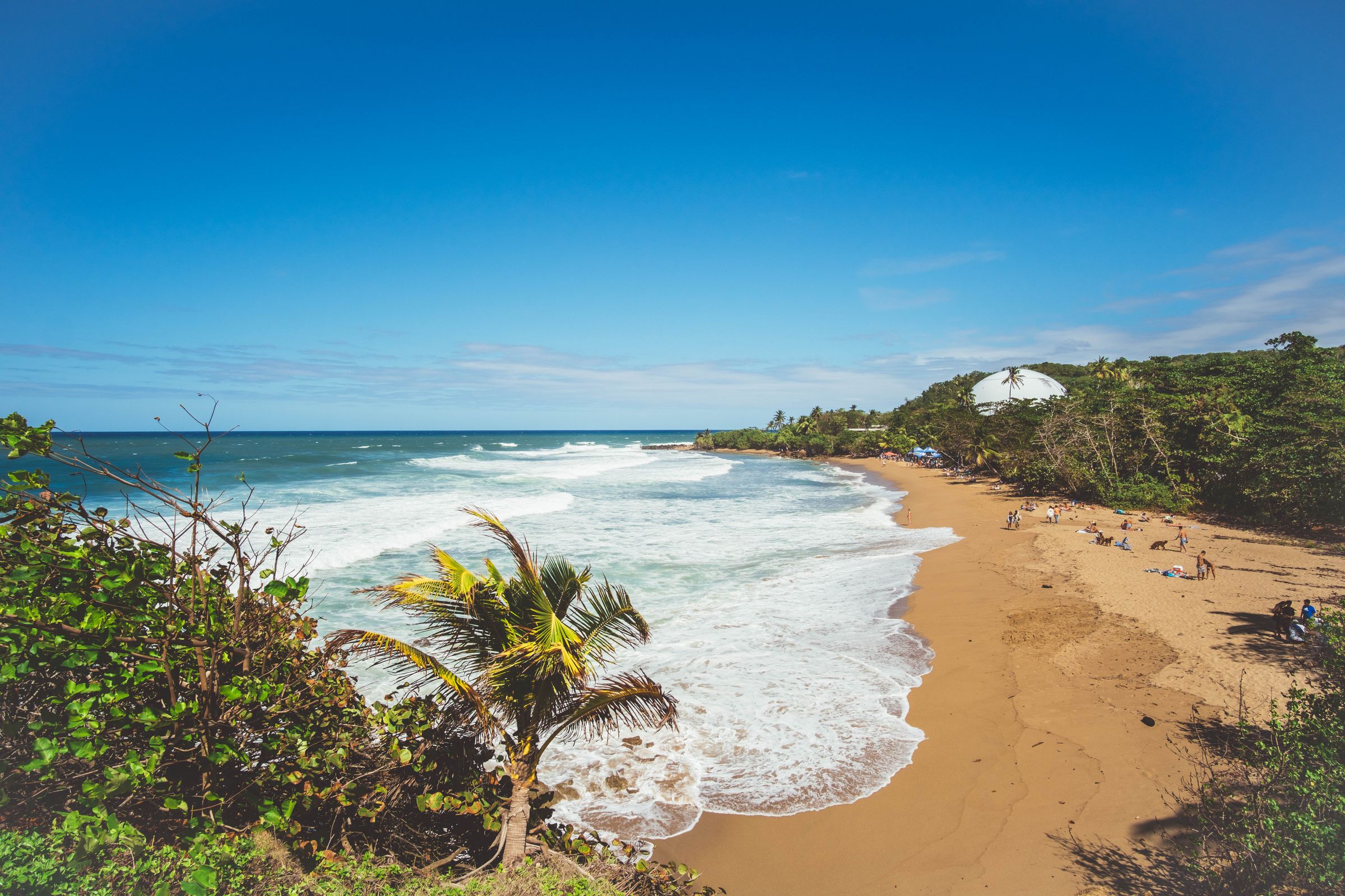 Aerial view of Domes Beach in Rincón, Puerto Rico, waves meeting the shore