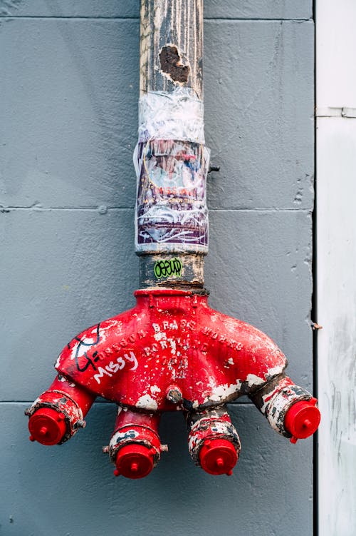 A red fire hydrant with a sticker on it
