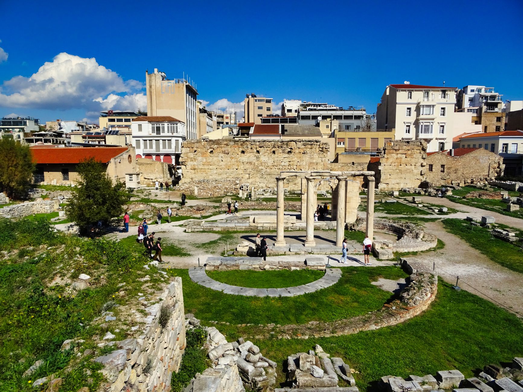 Explore the historic ruins of Hadrian's Library in Athens under a clear blue sky.