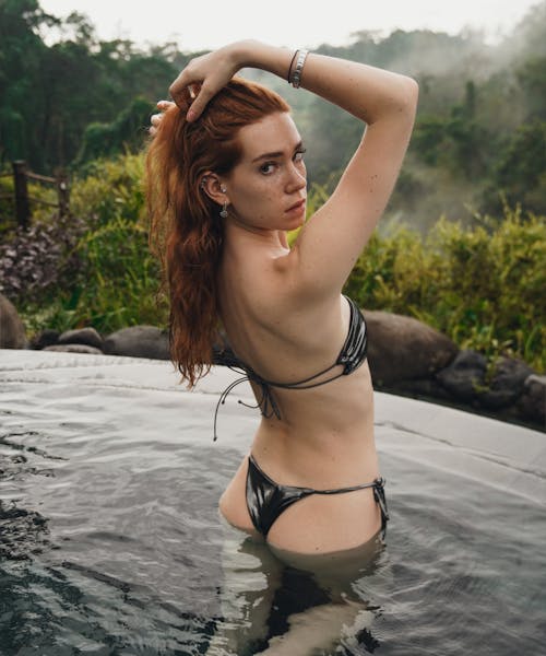 A woman in a bikini standing in a pool