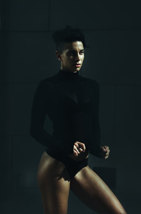Studio Shot of a Young Woman in a Black Blouse and Underwear 