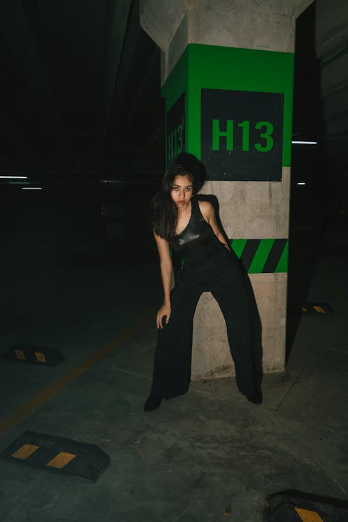Woman in Black Pants Posing in an Underground Parking Garage 