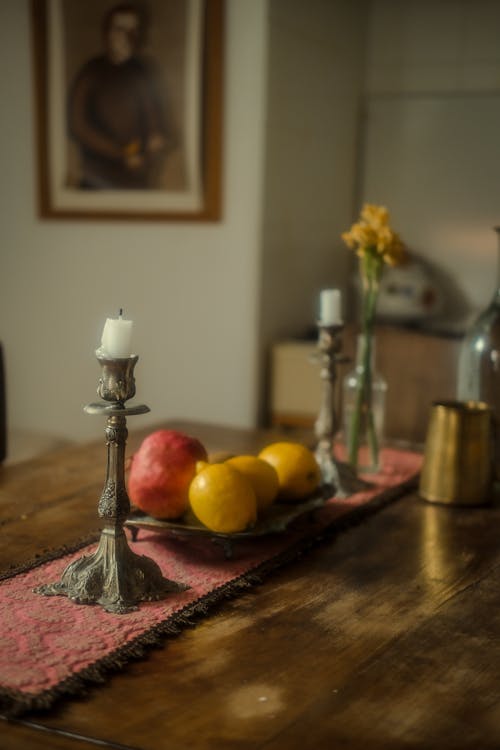 Candles and Fruits on a Kitchen Table 