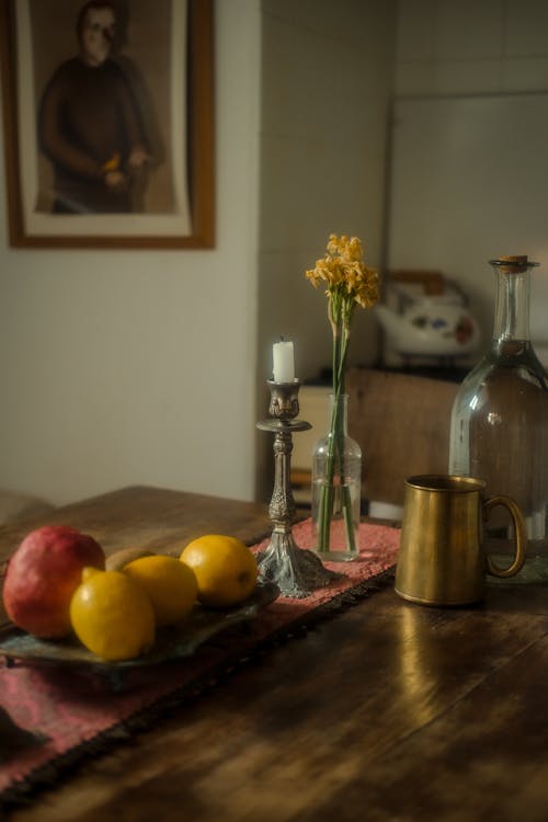 Fruits on a Plate and a Candle on a Table 