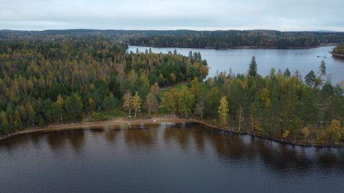 Free Aerial view capturing the serene lake and lush forests in Kronoberg County, Sweden. Stock Photo