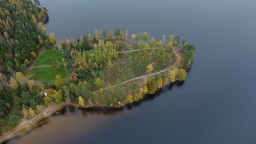 Free Aerial view of a forested peninsula surrounded by a lake in autumn colors, located in Kronoberg County, Sweden. Stock Photo