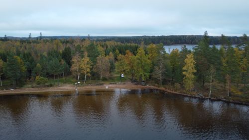 Free Scenic aerial view of lush forests and a tranquil lake in Kronoberg County, Sweden. Stock Photo