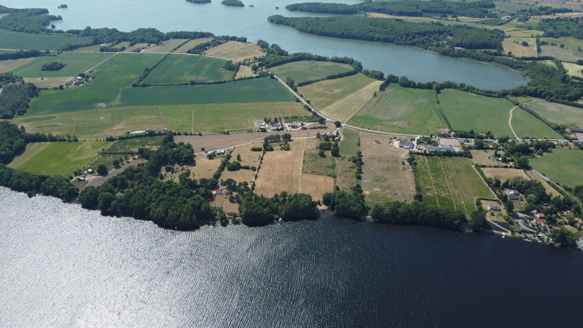 Aerial photo of Skåne County's vibrant fields and serene lakes. Ideal rural landscape.