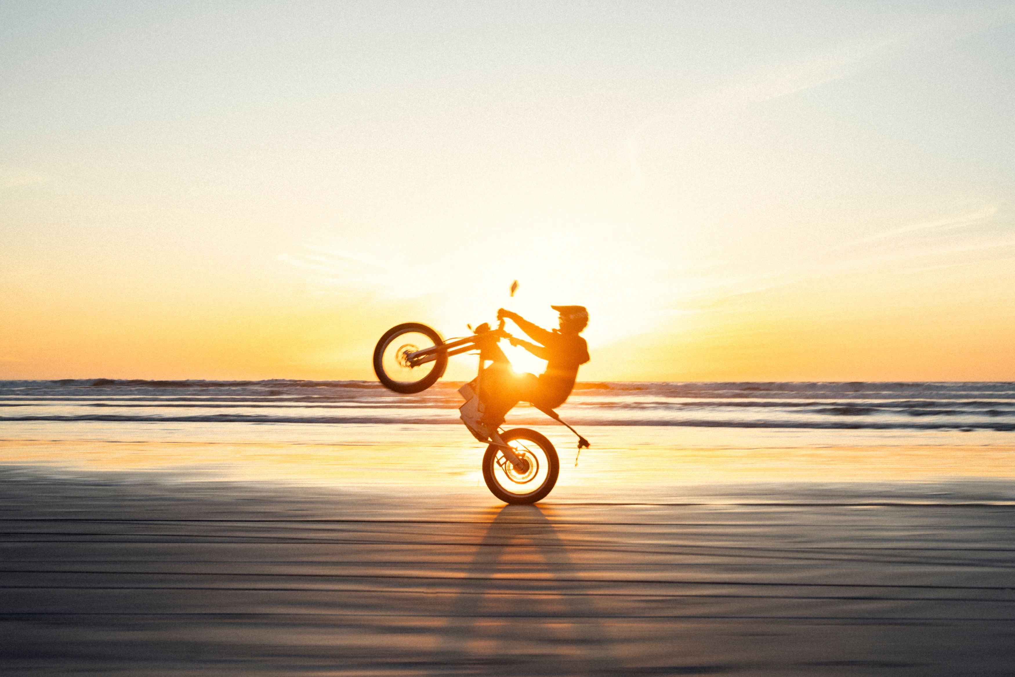 Man Riding Motocross on Beach at Sunset · Free Stock Photo