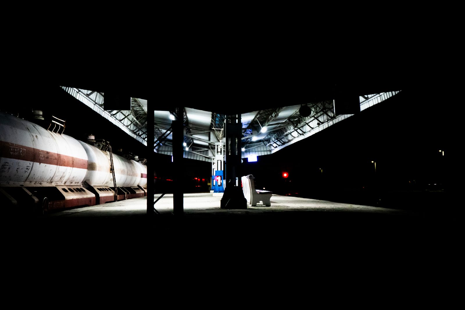 Train at an illuminated station during an evening connection