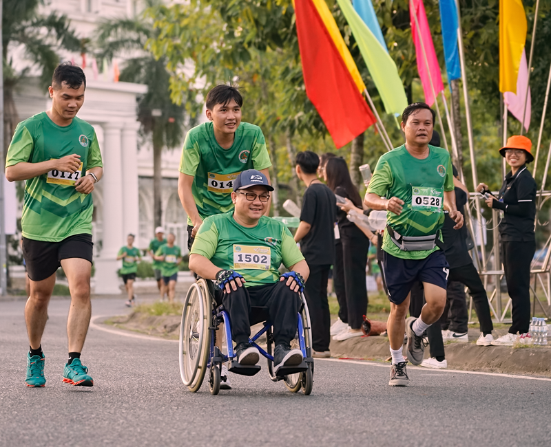 Group of diverse individuals participating in a fitness activity at an outdoor event