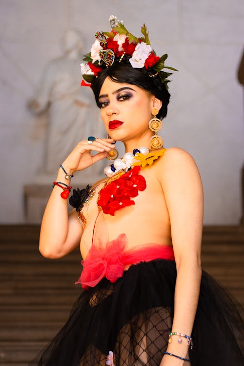 A woman in a black and red tutu and flower crown