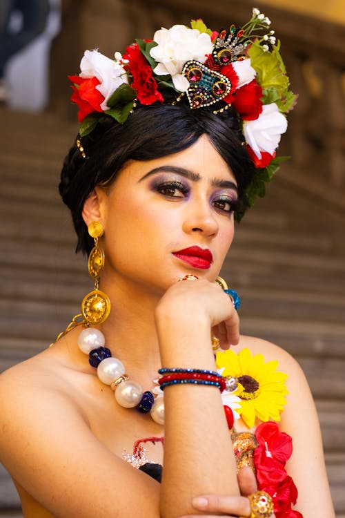A woman in a colorful dress and headpiece