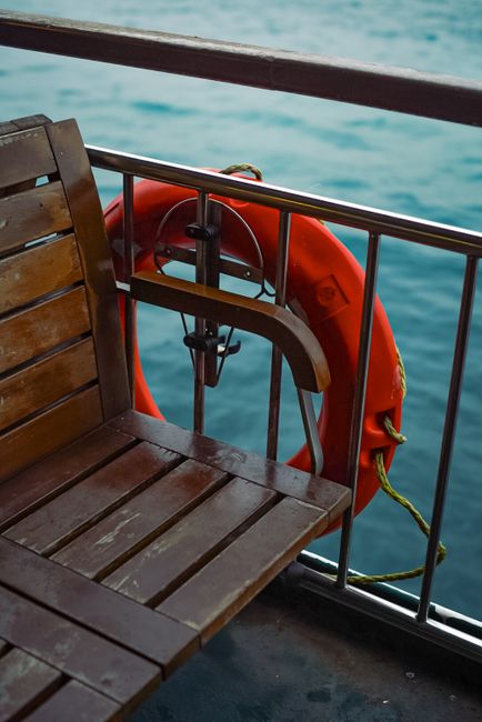 orange life jacket on ferry deck