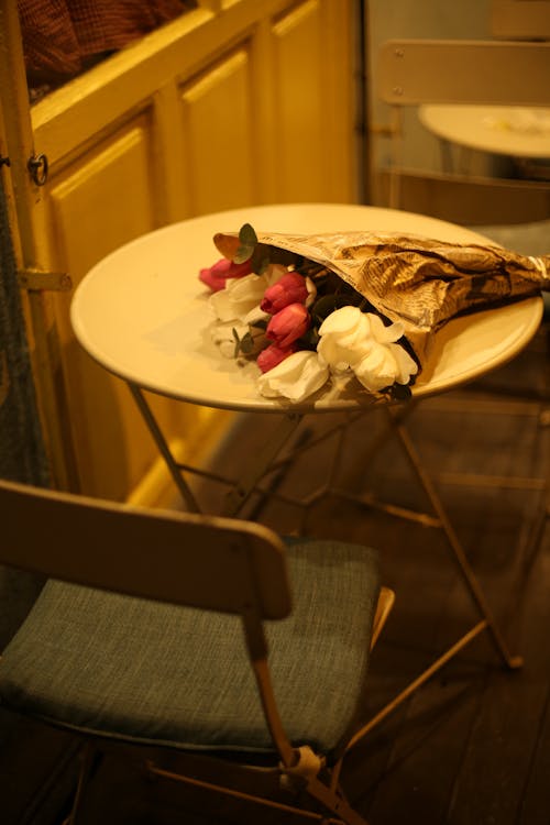 White and Pink Tulips Lying Down on Table