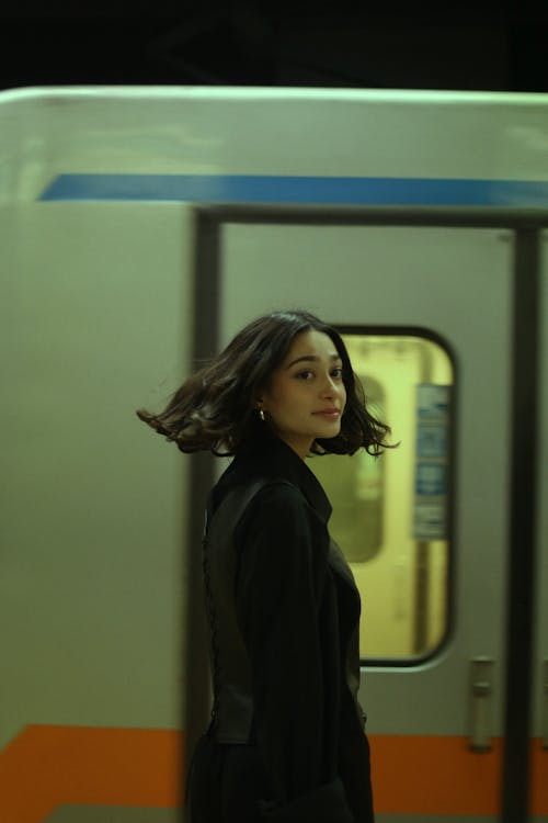 A Woman Standing by a Train