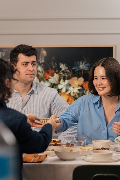 A family of four sitting at a table with food