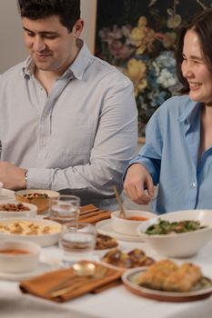 A couple enjoying a hearty meal together, showcasing vibrant food and laughter.