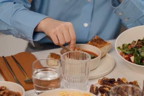 A person eating a meal with a plate of food