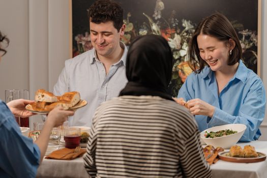 A cheerful group of friends enjoying a dinner party with delicious food and laughter.