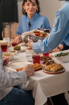 Family enjoying a homemade meal together, sharing food and conversations at a dining table.