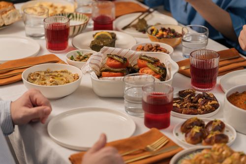 Free A vibrant table spread featuring Middle Eastern dishes, creating a warm dining atmosphere. Stock Photo