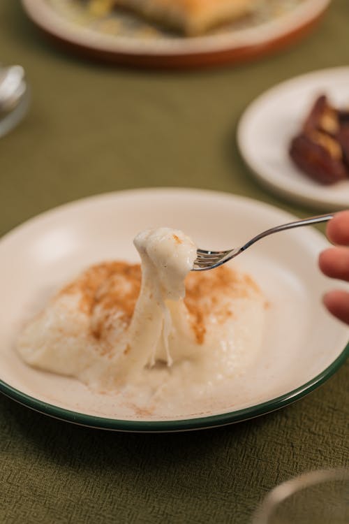 A person is eating a piece of food on a plate