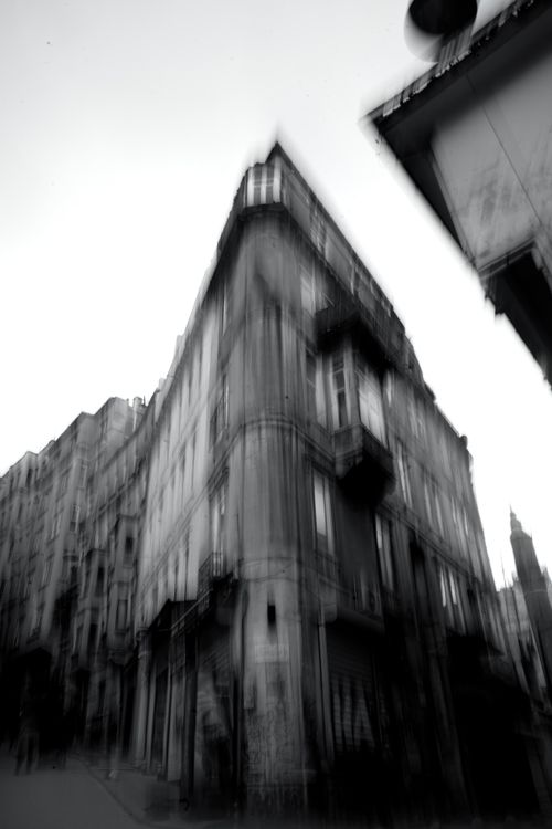 Free A dynamic view of urban architecture captured with a blurred effect, creating a moody cityscape. Stock Photo