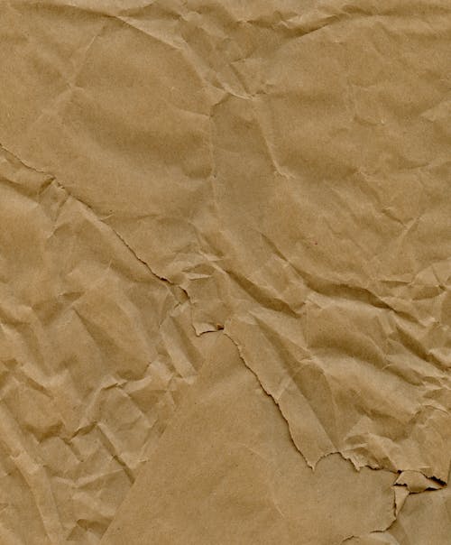 Crumpled paper texture with a brown background