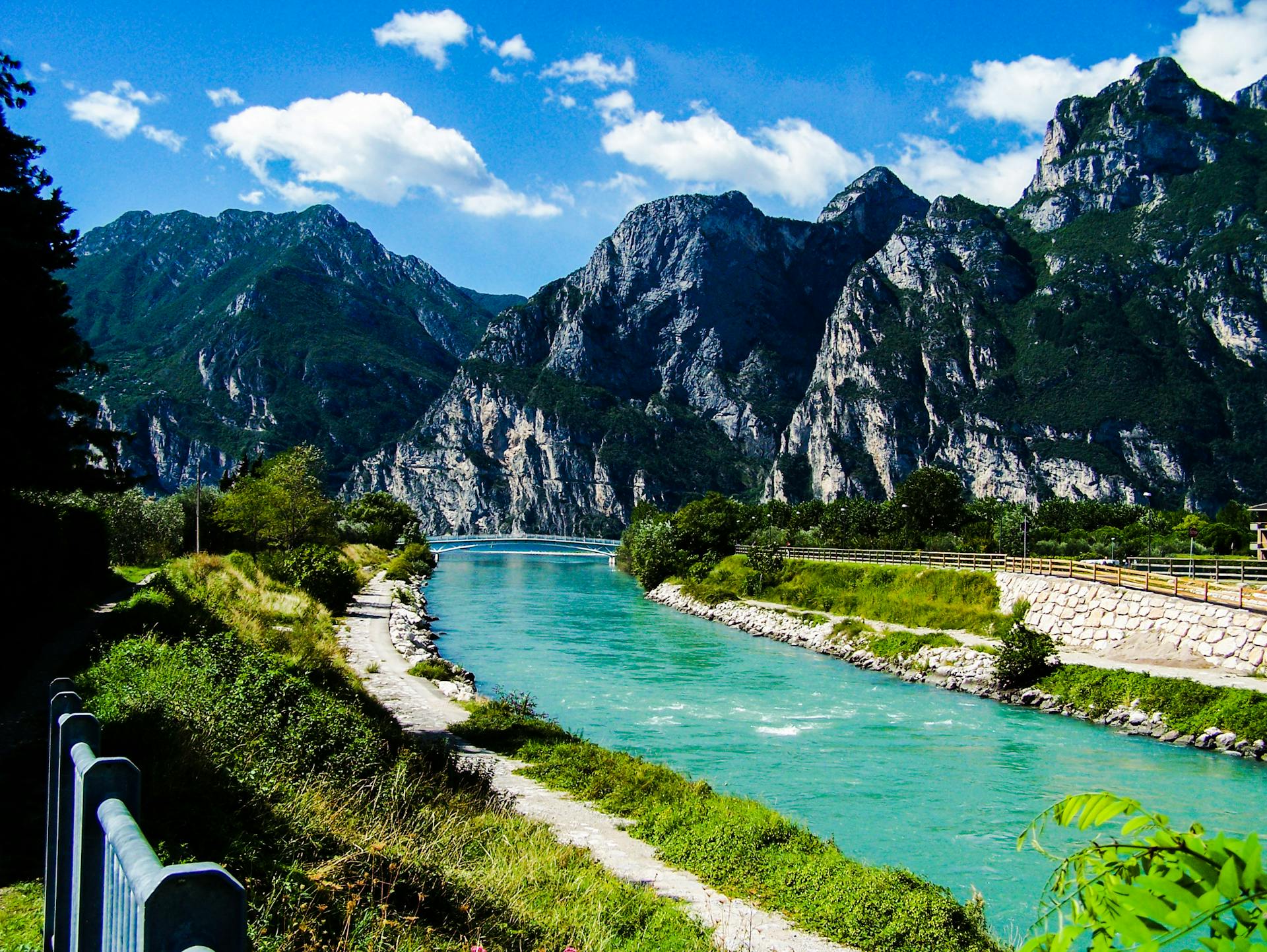 Beautiful view of turquoise lake and rugged mountains in Italy, perfect for travel inspiration.