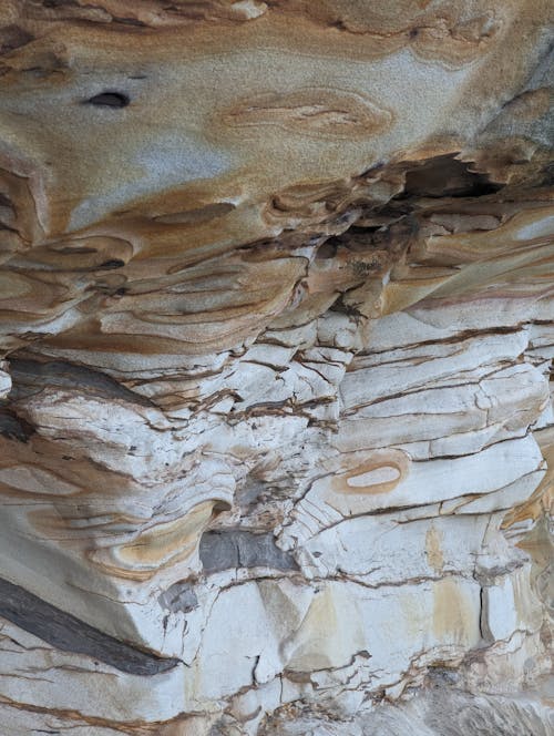 A close up of a rock formation with a hole in it