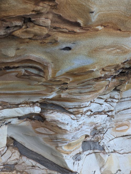 A close up of a rock formation with a hole in it
