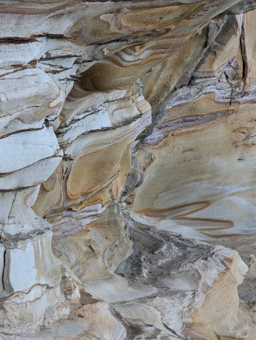 A close up of a rock formation with white and brown colors