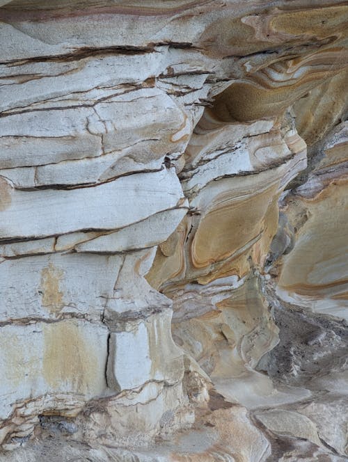 A close up of a rock formation with white and brown colors