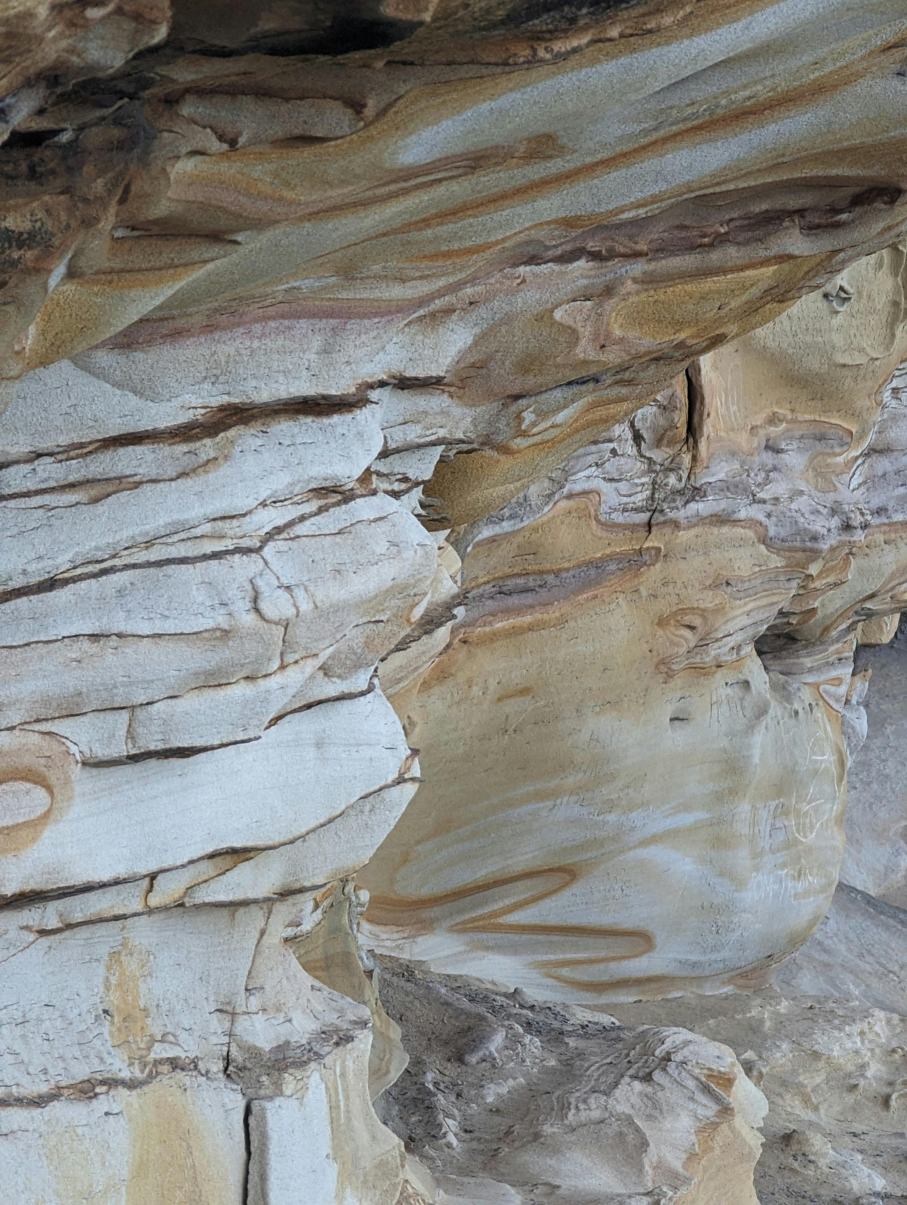 A detailed view of layered sandstone rocks displaying erosion and texture.