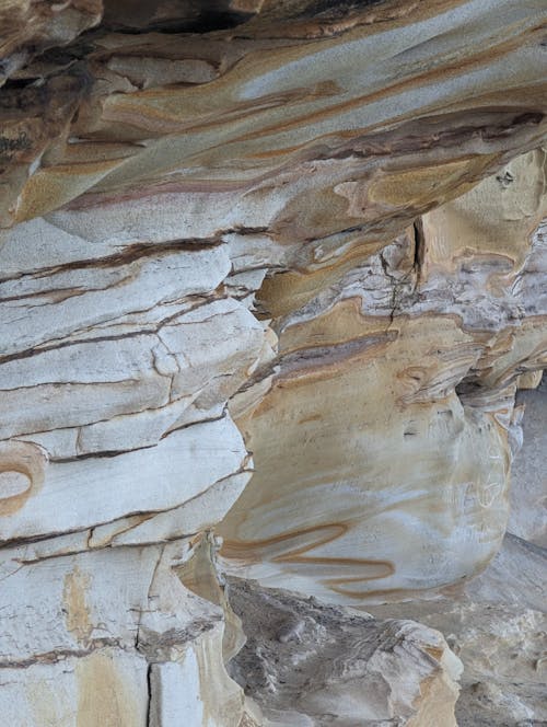 A rock formation with white and brown stripes