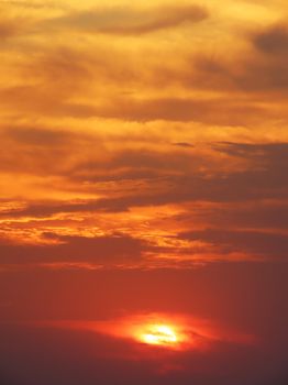 A stunning, vibrant sunset sky with dramatic clouds and warm tones, creating a serene atmosphere.