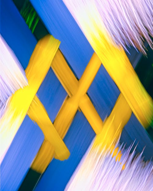 A close up of a yellow and blue abstract painting