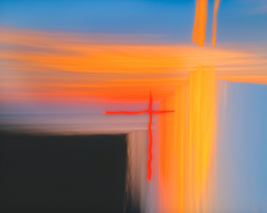 A painting of a cross in the sky with a sunset
