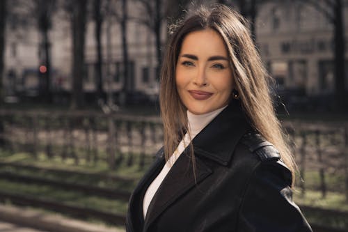 A woman in a leather jacket posing for a photo