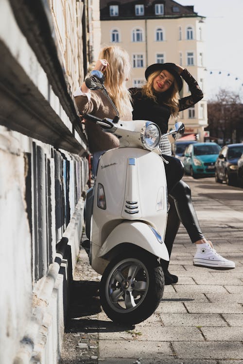 Women Posing on a Scooter