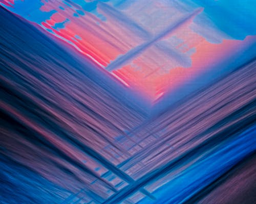 A painting with a blue and pink background