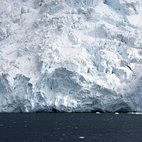 A large iceberg is floating in the water