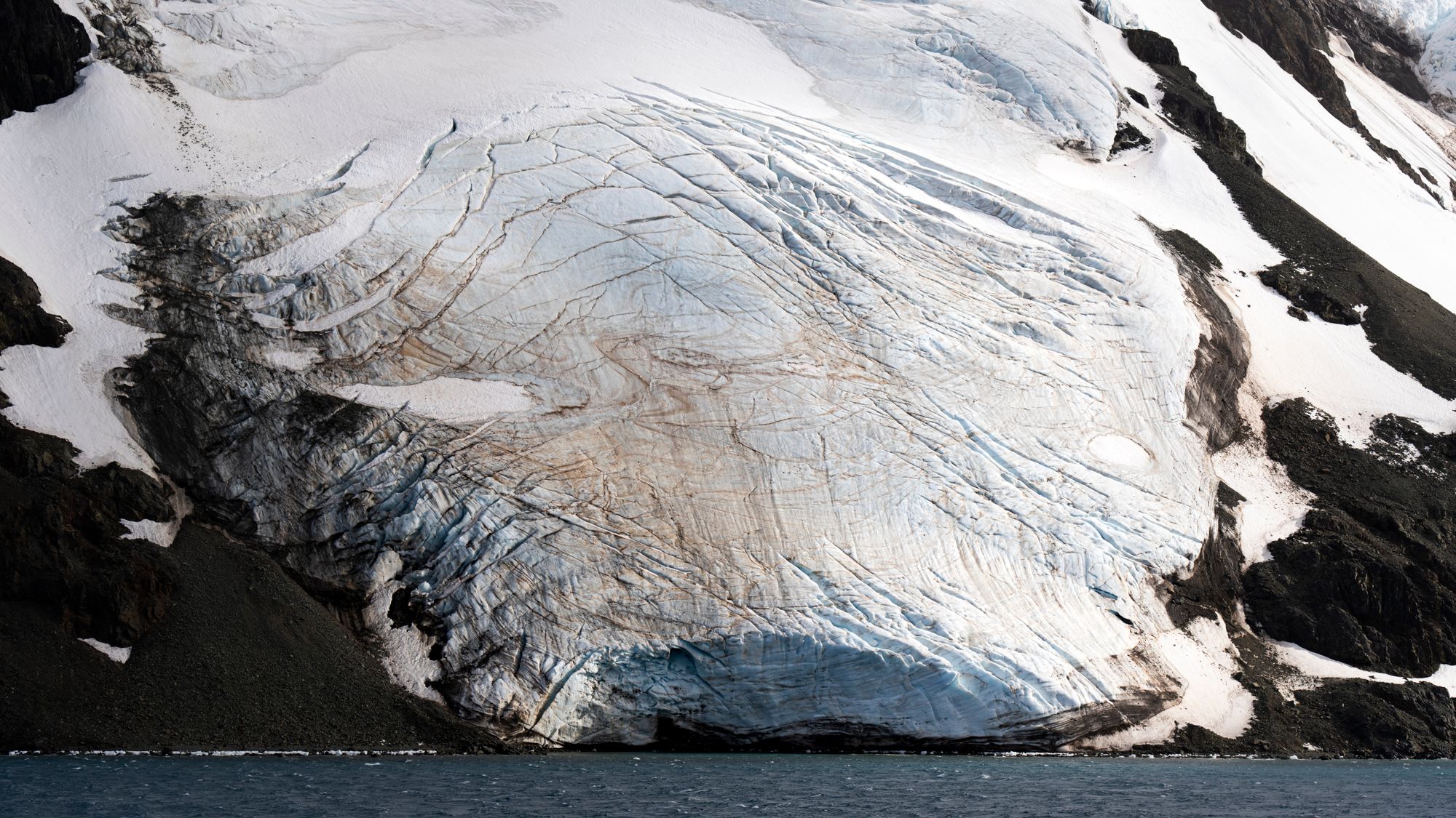 A breathtaking view of a glacier meeting the sea, showcasing natural beauty.