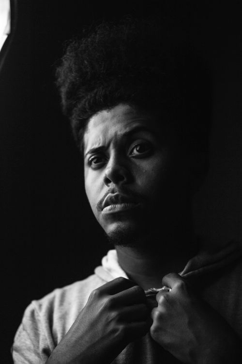 Free Monochrome close-up portrait of a man with expressive eyes and unique hairstyle. Stock Photo