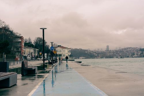 Free A moody scene along the Bosphorus in Istanbul with urban architecture and cloudy skies. Stock Photo