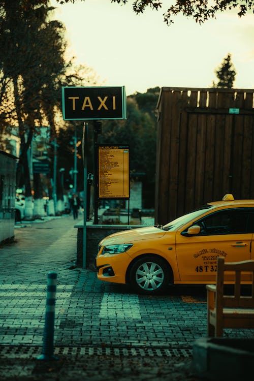 A taxi cab parked at a street corner